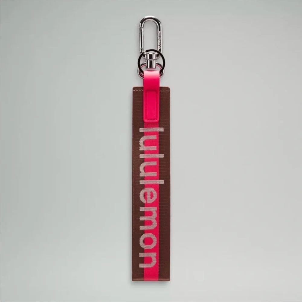 Lululemon Pink and Brown Never lost Word mark Keychain NWOT